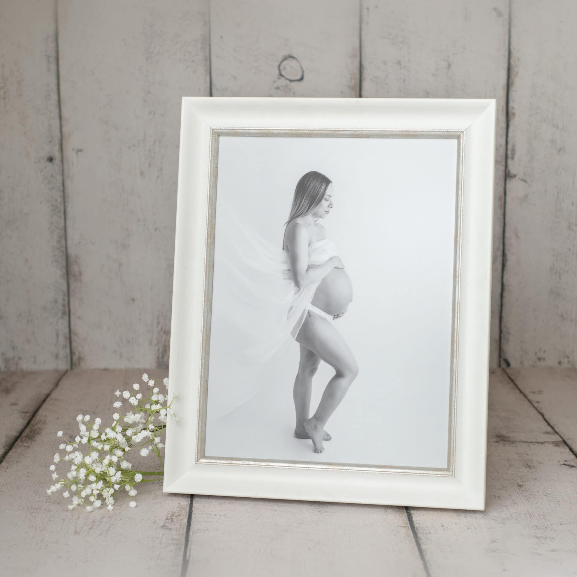 Kreativ gravidfotografering av kvinne med mage i et hvitt ramme, Oslo.